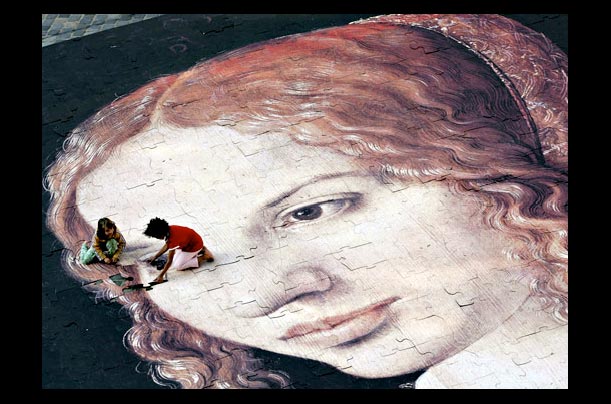 Children play on the giant Albrecht Duerer puzzle on the Sebalder Platz in Nuremberg, Germany