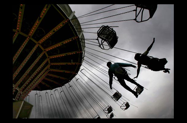 A young couple enjoy a merry-go-round ride at Munich's Oktoberfest beer festival A young couple enjoy a merry-go-round ride at Munich's Oktoberfest beer festival