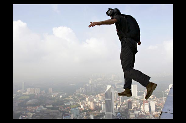 A Base jumper launches off Kuala Lumpur's KL Tower during the Malaysia's annual International Tower Jump event, which raised funds for the Malaysian Down Syndrome Association