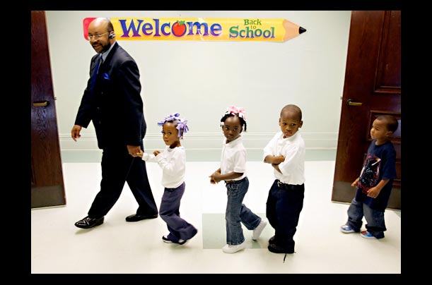Superintendent leads students to the cafeteria at Benjamin Franklin Elementary School in New Orleans after Hurricane Katrina