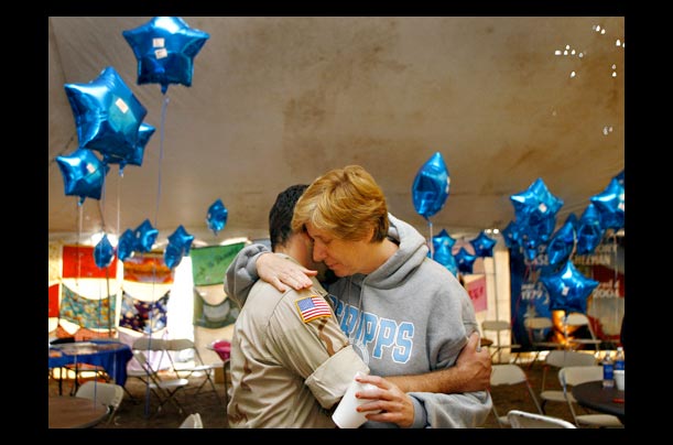Peace activist Cindy Sheehan hugs an Iraqi war veteran before a war protest near President Bush's ranch in Crawford, Texas