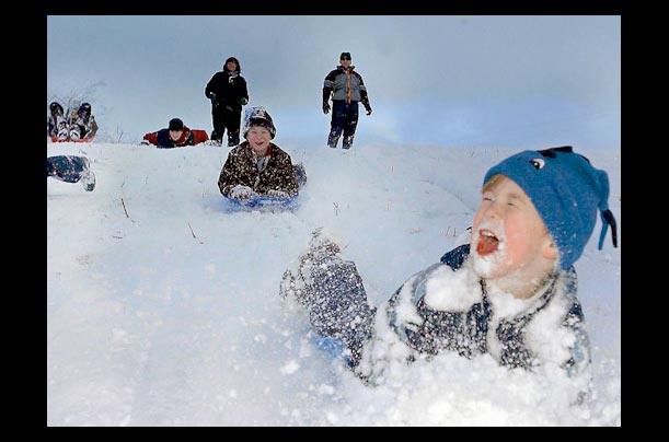 Five-year-old Charlie Greening sleds with family at sledges Beadlam in North Yorkshire after the first snow of the Winter season fell in northeast England