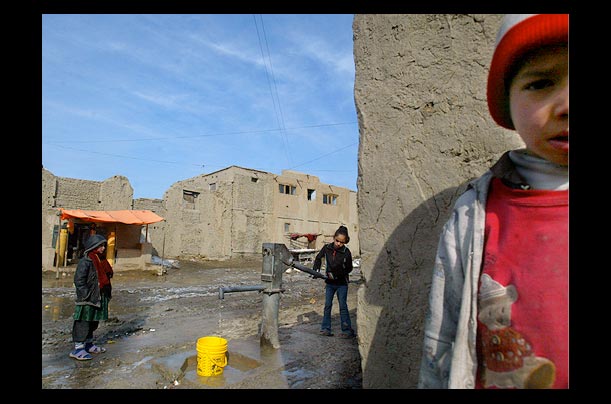 Afghan children pump water in the old city of Kabul