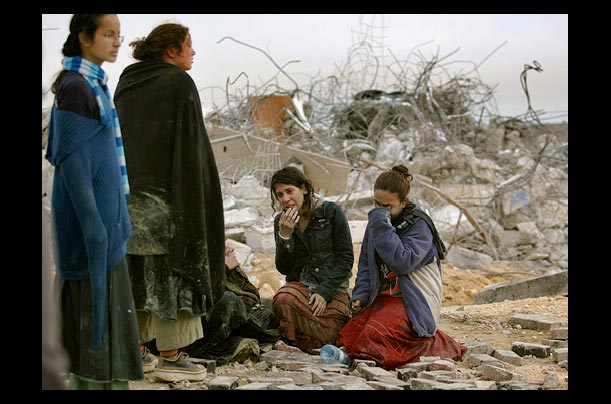 Israeli settlers weep after Israel's security forces evacuated the illegal West Bank settlement outpost of Amona