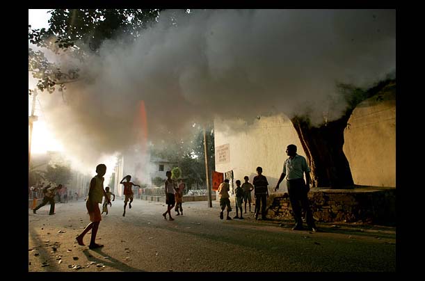 Children play in the fumes in Delhi, India