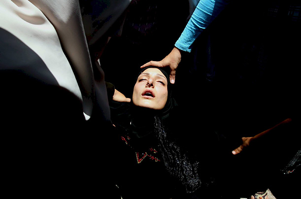 A woman cries during the funeral of Wissam al Kafarneh, 7, after he and his sister, Hala, 9, were killed by an explosion in Beit Lahiya, Gaza Strip.