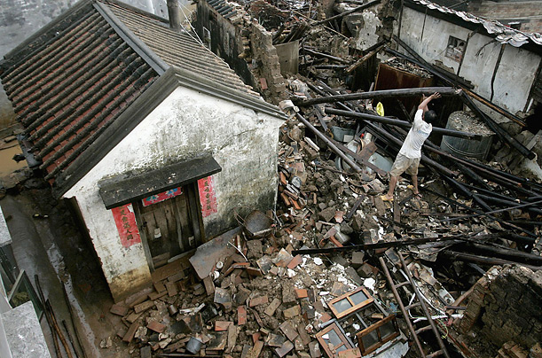A local resident searches for his belongings after his house was destroyed by floods in China's Guangdong province.