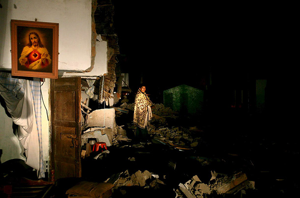 A survivor of the Peruvian quake walks in front of his destroyed house in Piscoin. A powerful earthquake hit Peru on Aug. 15, registering 8.0 on the Richter scale and killing more than 500.
A survivor of the Peruvian quake walks in front of his destroyed house in Piscoin. A powerful earthquake hit Peru on Aug. 15, registering 8.0 on the Richter scale and killing more than 500.