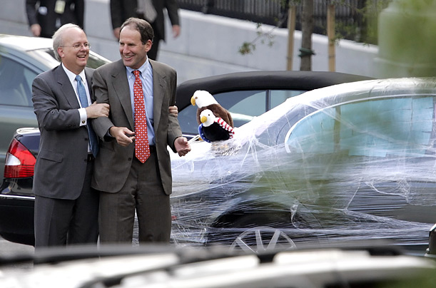 Karl Rove grabs ahold of Al Hubbard, chairman of the National Economic Council, after Rove's car was covered in plastic wrap and adorned with stuffed eagles and stickers supporting Democratic presidential candidate Barack Obama.
