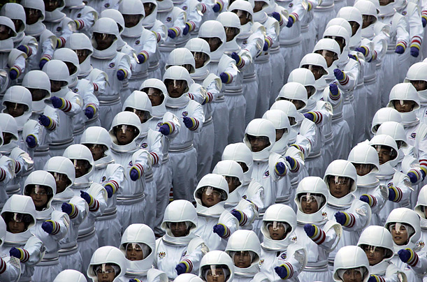 Malaysians in costume march in a parade commemorating 50 years of independence in Kuala Lumpur.