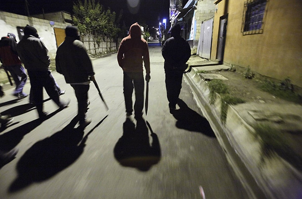 A citizen security patrol walks through Guatemala City as part of an effort to control a surging crime wave.