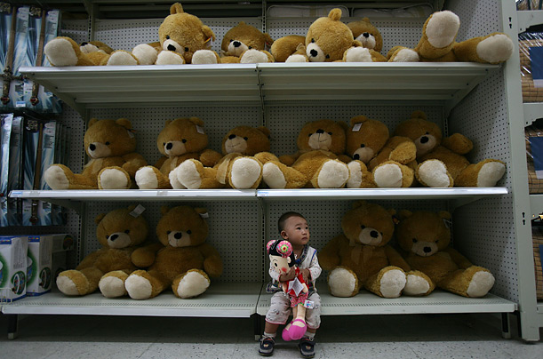 A boy sits at a toy stall at a Wal-Mart supermarket in Chongqing, China.
