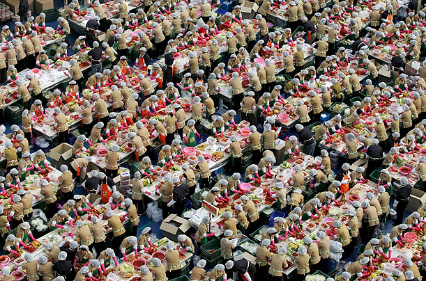 Workers of the South Korean company Yakult make kimchi, a traditional spicy Korean side-dish for distribution to needy neighbors.