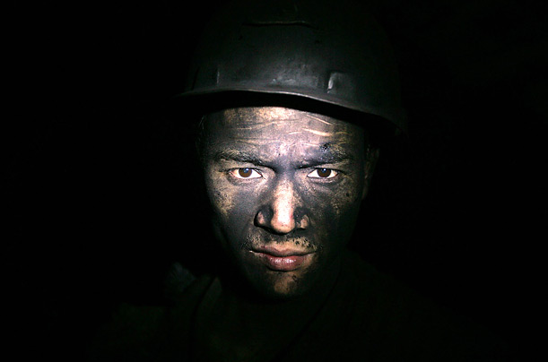 A miner at the Moxinpo Colliery in Chongqing, China. According to state media, accidents in China's coal mines claimed over 5,000 lives each year, accounting for around 80 percent of the world's total deaths.