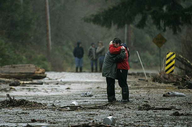 Amy Anderson hugs Melanie Tapia after a flash flood swept through their restaurant, the Ranch House BBQ, near Olympia, Washington.