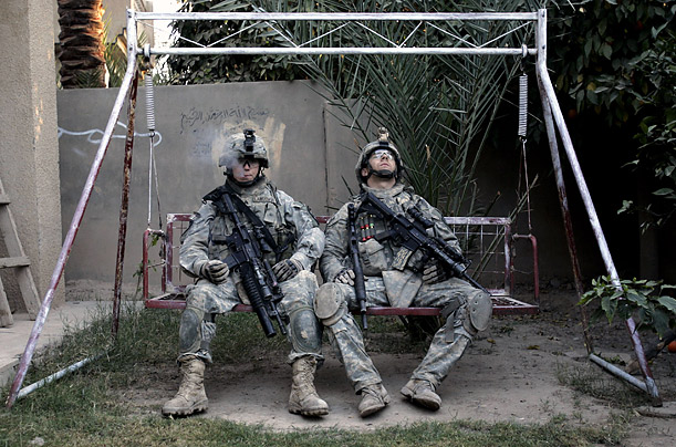 U.S. army soldiers take a break after searching a house during a clearance mission on the outskirts of Muqdadiyah, in the volatile Diyala province, about 60 miles north of Baghdad.