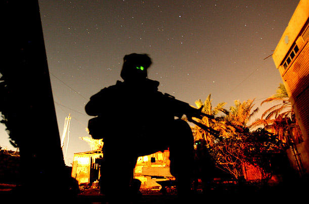 US Soldiers secure an area after dark in Baghdad.