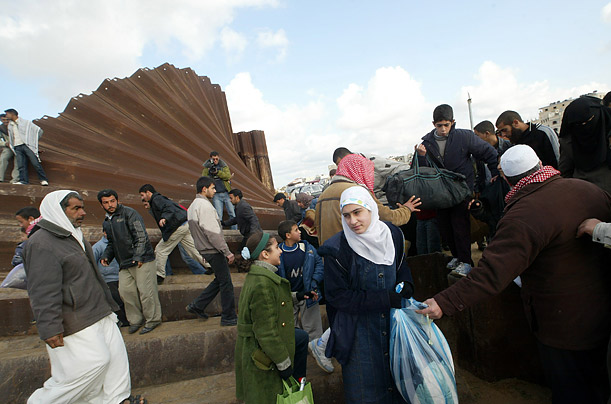 Palestinians cross into Egypt after militants destroyed a border wall between Gaza and Egypt at Rafah refugee camp, southern Gaza Strip.   
