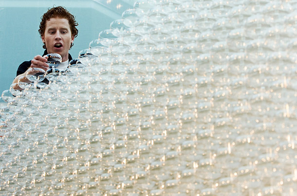 A worker adjusts glasses in an attempt to break the world record for the 