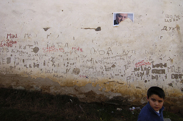 A boy passes a building where a poster supporting Serbian presidential candidate Tomislav Nikolic has been ripped from the wall. Nationalist Nikolic narrowly lost the vote to pro-western candidate Boris Tadic.