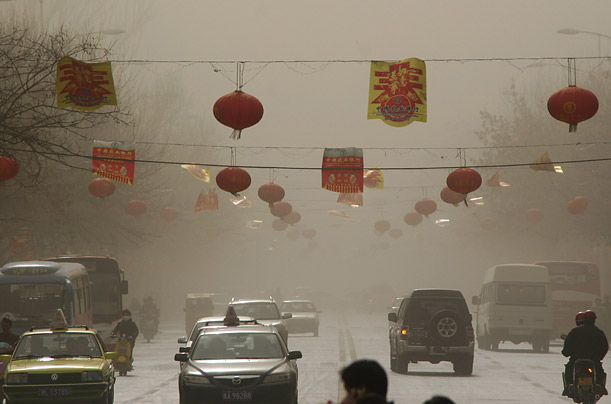Vehicles move on a street during a sandstorm in Hami, northwest China's Xinjiang Uygur Autonomous Region. 

