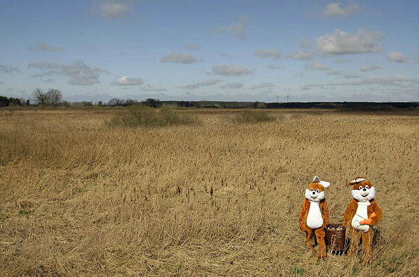 Two men dressed as Easter Bunnies pose in a field near Mellensee, south of Berlin.