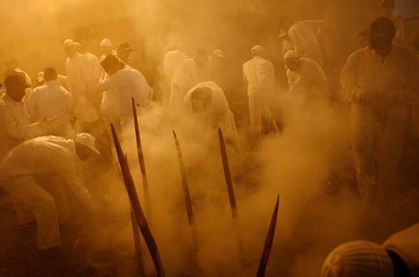 Members of the ancient Samaritan community work around a fire-pit where they have placed sheep on stakes as part of a traditional Passover sacrifice on Mount Gerizim, near the West Bank town of Nablus.