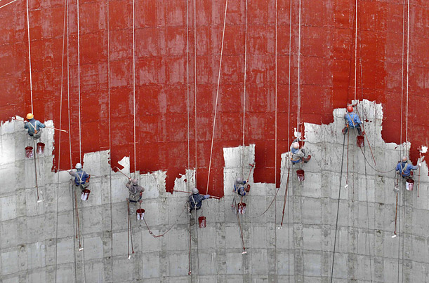Workers paint a wall at a power plant in Huaibei, China.