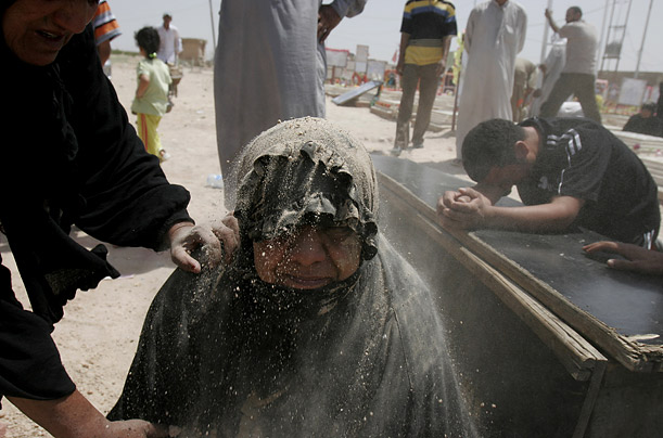 A woman grieves for her son, Ayad Hafidh, as he is buried in the Shiite holy city of Najaf, south of Baghdad, Iraq.