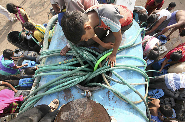 
People crowd around a water tanker to fill their buckets and pots on a hot day in the western Indian city of Ahmedabad.
