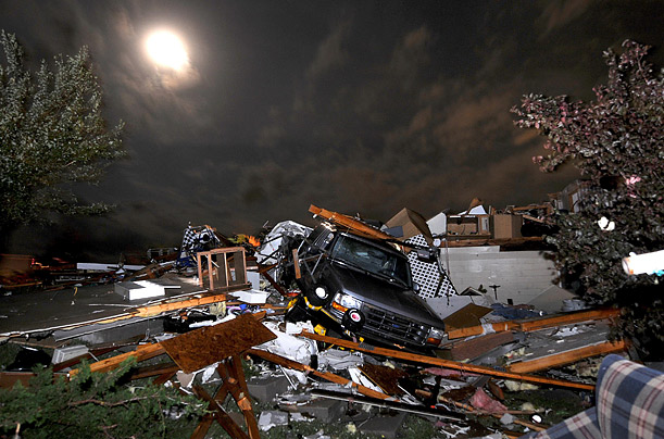 A pickup truck lies in the wreckage on Holmes Road southeast of Salina, Kansas, after a tornado passed through the area.     
