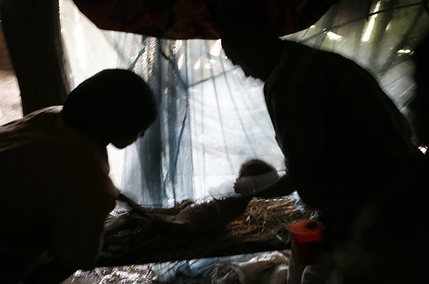 Relatives wash the body of Michu Mohamed, a four-year-old girl who died of malnutrition near Sheshemene, southern Ethiopia. The lack of rain and high food prices have left approximately 4.5 million Ethiopians in need of emergency food aid. 
