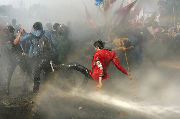 Indonesian police spray water cannons to disperse protesters demonstrating against increases in fuel prices outside the parliament building in Jakarta.
