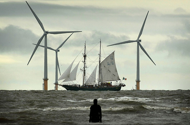 A Tall Ship sails past the Burbo Bank windfarm on the approach to the Port of Liverpool in England. One hundred vesselsracing festival 
