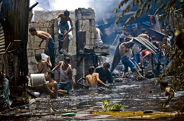 Filipinos retrieve whatever belongings they can find after a fire razed a slum area and injured at least four in Manila 



