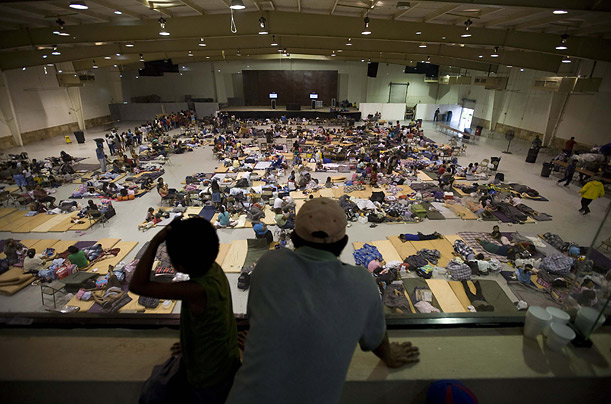 A man and his son look out over the women's section at a shelter for victims of Hurricane Dolly in Matamoros, Mexico



