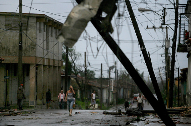 Residents make their way through a street in Consolacion del Sur, Cuba after the Hurricane roared across the island and into the oil-rich Gulf of Mexico.