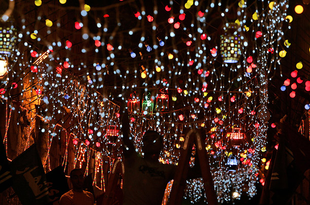 An alley of Jerusalem's old city shimmers with festive lights in preparation for  Ramadan.