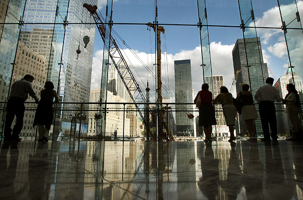 People watch construction of the Freedom Tower on the site of the former World Trade Center on the day before the seventh anniversary of the 9/11 attacks.