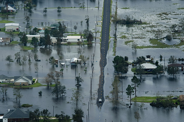 A car reaches the end of dry road in a neighborhood flooded by Hurricane Ike near Winnie, Texas.

