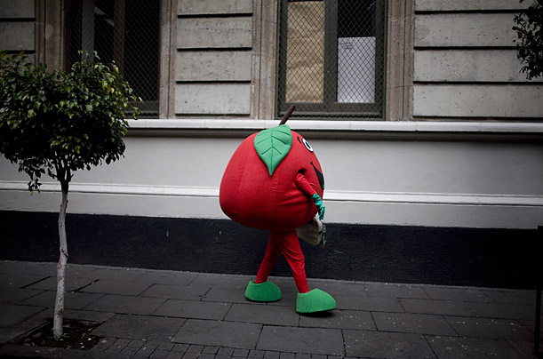 A Greenpeace activist, dressed as an apple, protests the selling of junk food in Mexico's public schools outside the Secretary of Education headquarters in Mexico City.