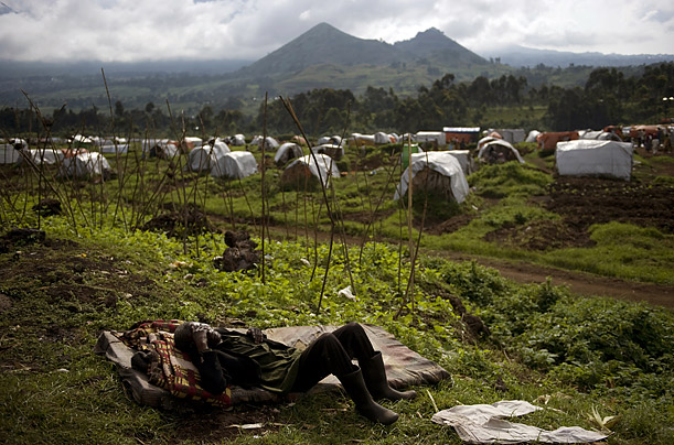 A man sleeps on a mattress outside a school near the Kibumba refugee camp, which is filled with people trying to escape violence in the Democratic Republic of Congo.

