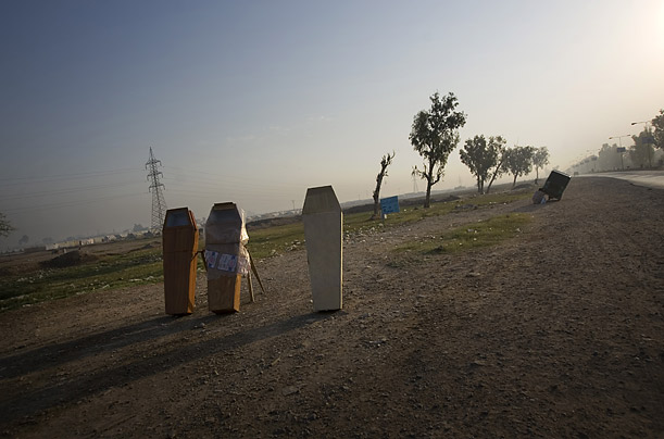 Coffins are sold by the side of a road on the outskirts of Peshawar, Pakistan.

