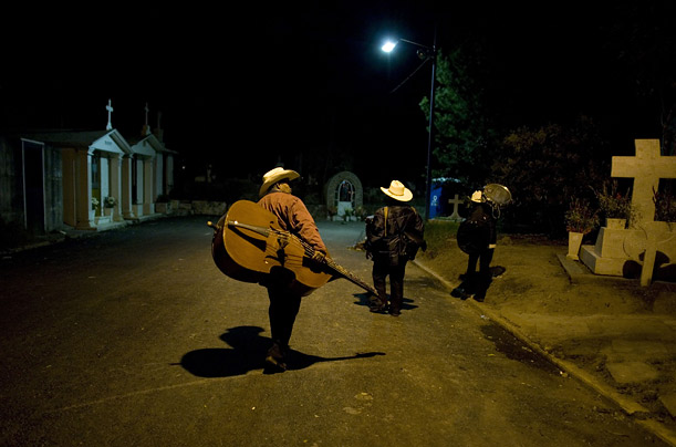 Musicians trawl a cemetery looking for clients during Day of the Dead celebrations in Xilotepec, Mexico.


