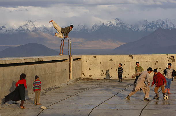 People play in an empty swimming pool in Kabul, Afghanistan.

