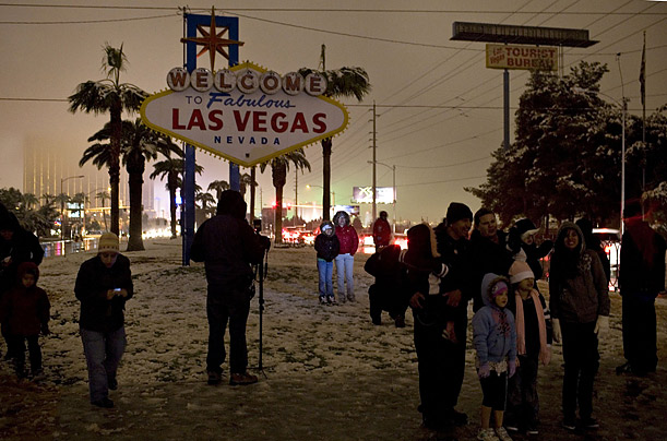 People walk through a rare snowfall in Las Vegas.

