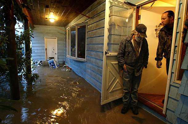 Don Steed, left, and his son-in-law, Ben Swift, right, stand on Steed's flooded porch after relentless rain caused severe flooding in Orting, Washington.
Don Steed, left, and his son-in-law, Ben Swift, right, stand on Steed's flooded porch after relentless rain caused severe flooding in Orting, Washington.