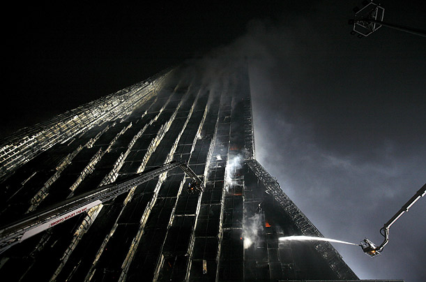 A part of Beijing's iconic CCTV complex is engulfed in flames in downtown Beijing, 

