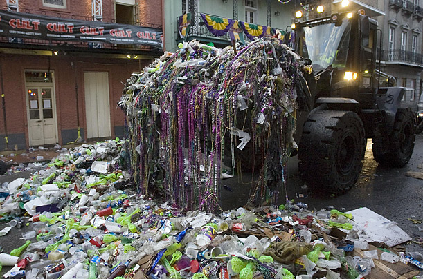 A front-end loader removes trash left on Bourbon Street after Mardi Gras celebrations in New Orleans.

