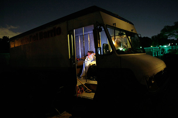 Mary Trody watches President Obama's speech before Congress on a television in the van she and her family are living in as it is parked in front of their foreclosed home.

